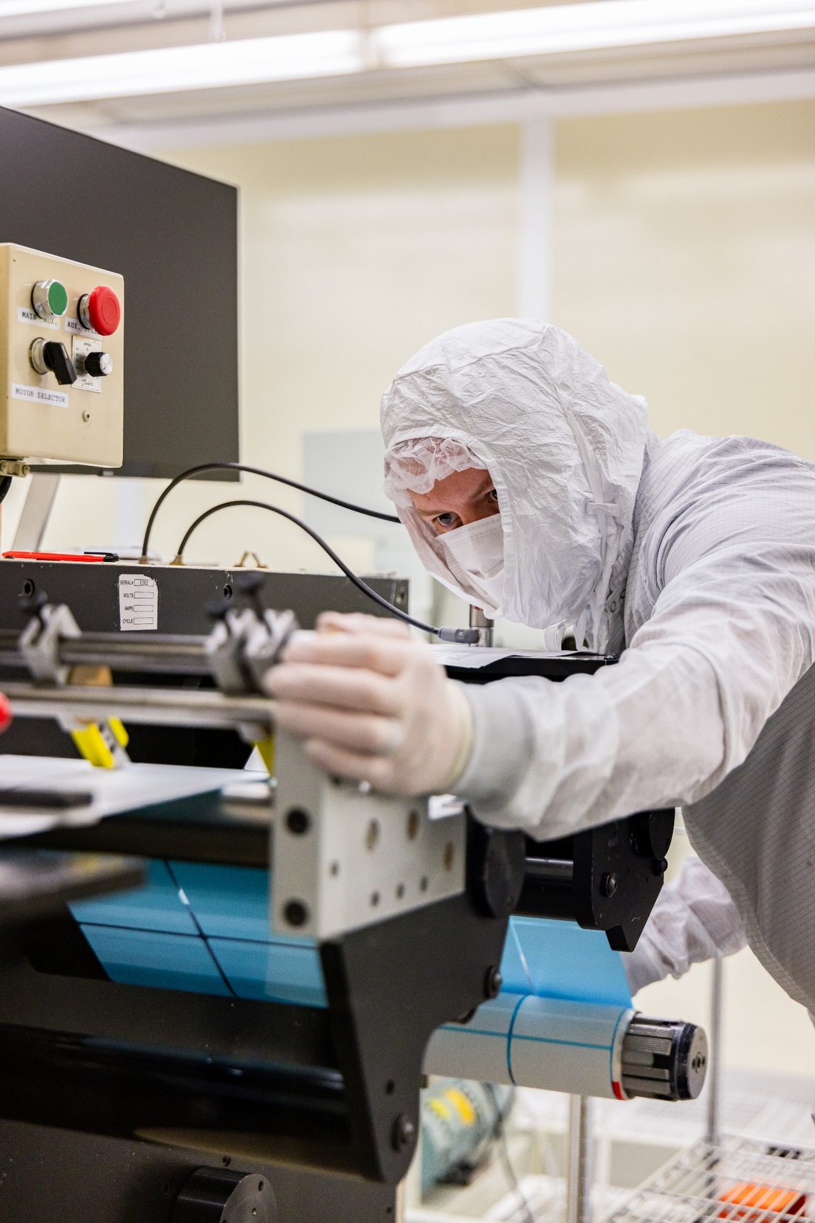 CleanMark cleanroom technician adjusting label production equipment in a controlled environment